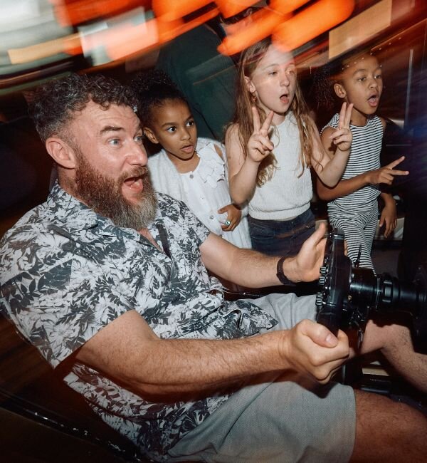 A family enjoying a racing simulator at F1 Arcade Philadelphia